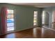 Bedroom with hardwood floors and pool view at 3151 Carlos Dr, Dunedin, FL 34698