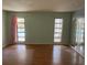 Bright bedroom with pool view and wood floors at 3151 Carlos Dr, Dunedin, FL 34698