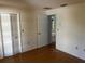 Bedroom with hardwood floors and view to another room at 3151 Carlos Dr, Dunedin, FL 34698