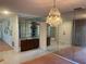 Dining room with mirrored wall and chandelier at 3151 Carlos Dr, Dunedin, FL 34698