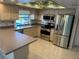 L-shaped kitchen boasting stainless steel appliances and ample counter space at 3151 Carlos Dr, Dunedin, FL 34698