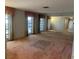 Spacious living room featuring large windows and mirrored wall at 3151 Carlos Dr, Dunedin, FL 34698