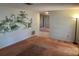 Living room with scenic wall mural and view to entryway at 3151 Carlos Dr, Dunedin, FL 34698