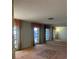 Bright living room with large windows and mirrored wall at 3151 Carlos Dr, Dunedin, FL 34698