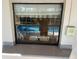 View of the pool through a window at 3151 Carlos Dr, Dunedin, FL 34698