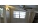 Living room with window, ceiling fan, and view into kitchen at 4011 W Mango Ave, Tampa, FL 33616