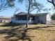 Home's rear elevation and partially fenced backyard at 4230 Lee Rd, Spring Hill, FL 34608
