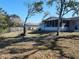 Spacious backyard with screened porch and mature trees at 4230 Lee Rd, Spring Hill, FL 34608