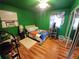 Bedroom with full-size bed and wood flooring at 4230 Lee Rd, Spring Hill, FL 34608