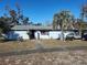 Ranch style home with carport and mature landscaping at 4230 Lee Rd, Spring Hill, FL 34608