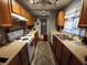 Galley style kitchen with wood cabinets and neutral countertops at 4230 Lee Rd, Spring Hill, FL 34608