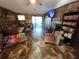 Living room with wood-paneled accent wall and tile floor at 4230 Lee Rd, Spring Hill, FL 34608