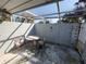 Small covered patio with plastic table and chairs at 4230 Lee Rd, Spring Hill, FL 34608