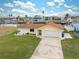 Bright yellow house with a large yard, two-car garage, and waterfront access at 4270 Paradise Cir, Hernando Beach, FL 34607