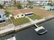 Aerial view of waterfront home with private dock and boat at 4270 Paradise Cir, Hernando Beach, FL 34607