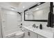 Bathroom with white tub, black accents and vanity at 4270 Paradise Cir, Hernando Beach, FL 34607