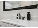Modern bathroom with white sink and black faucet at 4270 Paradise Cir, Hernando Beach, FL 34607