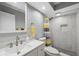 Updated bathroom with white vanity and marble shower at 4270 Paradise Cir, Hernando Beach, FL 34607
