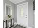 Modern entryway with a white door and a stylish console table at 4270 Paradise Cir, Hernando Beach, FL 34607