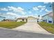 Newly renovated home with a large driveway and a lush green lawn at 4270 Paradise Cir, Hernando Beach, FL 34607