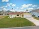 Single story home, yellow exterior, 2 car garage, and well maintained lawn at 4270 Paradise Cir, Hernando Beach, FL 34607