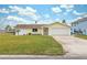 Cute yellow house with white trim and a spacious yard at 4270 Paradise Cir, Hernando Beach, FL 34607