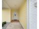 Inviting entryway with a white door and terracotta tile flooring at 4270 Paradise Cir, Hernando Beach, FL 34607