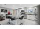 Modern kitchen with white cabinets, granite countertops, and island seating at 4270 Paradise Cir, Hernando Beach, FL 34607