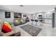 Open living space with modern sofas and a view into the kitchen at 4270 Paradise Cir, Hernando Beach, FL 34607