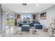 Bright living room with blue sectional sofa and water view at 4270 Paradise Cir, Hernando Beach, FL 34607