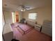 Bedroom with ceiling fan and large window with blinds at 4351 Castle Ave, Spring Hill, FL 34609