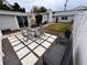 Backyard patio with seating area and grassy lawn at 4602 W Hawthorne Rd, Tampa, FL 33611