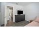 Bright bedroom with a dresser, TV and view of hallway at 4602 W Hawthorne Rd, Tampa, FL 33611