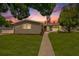 Updated one-story home with gray exterior, landscaped lawn, and walkway at 4602 W Hawthorne Rd, Tampa, FL 33611