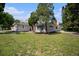 Single-story home with gray exterior, American flag, and lush lawn at 4602 W Hawthorne Rd, Tampa, FL 33611