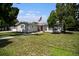 Ranch-style home with gray exterior, well-maintained lawn, and walkway at 4602 W Hawthorne Rd, Tampa, FL 33611