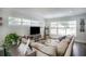 Spacious living room with large windows, sectional sofa, and TV at 4602 W Hawthorne Rd, Tampa, FL 33611