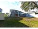Large backyard with a screened enclosure and grassy area at 4634 Mapletree Loop, Wesley Chapel, FL 33544