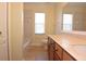 Clean bathroom with tub, toilet, and wood vanity at 4634 Mapletree Loop, Wesley Chapel, FL 33544