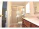 Bathroom with shower stall, toilet and wood vanity at 4634 Mapletree Loop, Wesley Chapel, FL 33544