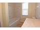 Simple bathroom with a bathtub and neutral color palette at 4634 Mapletree Loop, Wesley Chapel, FL 33544