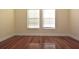 Bright bedroom with hardwood floors and large windows at 4634 Mapletree Loop, Wesley Chapel, FL 33544