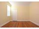 Simple bedroom with hardwood floors and large window at 4634 Mapletree Loop, Wesley Chapel, FL 33544