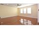 Bright bonus room with hardwood floors and large windows at 4634 Mapletree Loop, Wesley Chapel, FL 33544