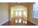 Spacious dining room with hardwood floors and arched doorway at 4634 Mapletree Loop, Wesley Chapel, FL 33544