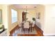 Formal dining room with hardwood floors, large window, and chandelier at 4634 Mapletree Loop, Wesley Chapel, FL 33544