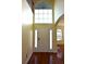Bright entryway with hardwood floors, large windows, and a double door at 4634 Mapletree Loop, Wesley Chapel, FL 33544