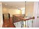 Open hallway with hardwood floors and elegant railings at 4634 Mapletree Loop, Wesley Chapel, FL 33544