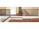Hardwood floors and elegant staircase with wrought iron railings at 4634 Mapletree Loop, Wesley Chapel, FL 33544