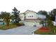 Two-story house with a two-car garage and palm trees at 4634 Mapletree Loop, Wesley Chapel, FL 33544